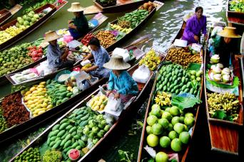 Locals selling fresh tropical fruits on boats
